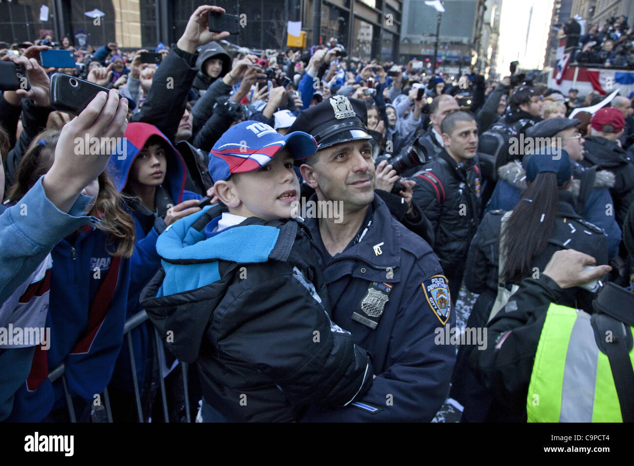 Feb. 7, 2012 - New York, New York, U.S - During the Superbowl Champion Parade fans cheer their winning team the New York Giants riding up Broadway Ave. in Lower Manhattan. (Credit Image: © Gary Dwight Miller/ZUMAPRESS.com) Stock Photo