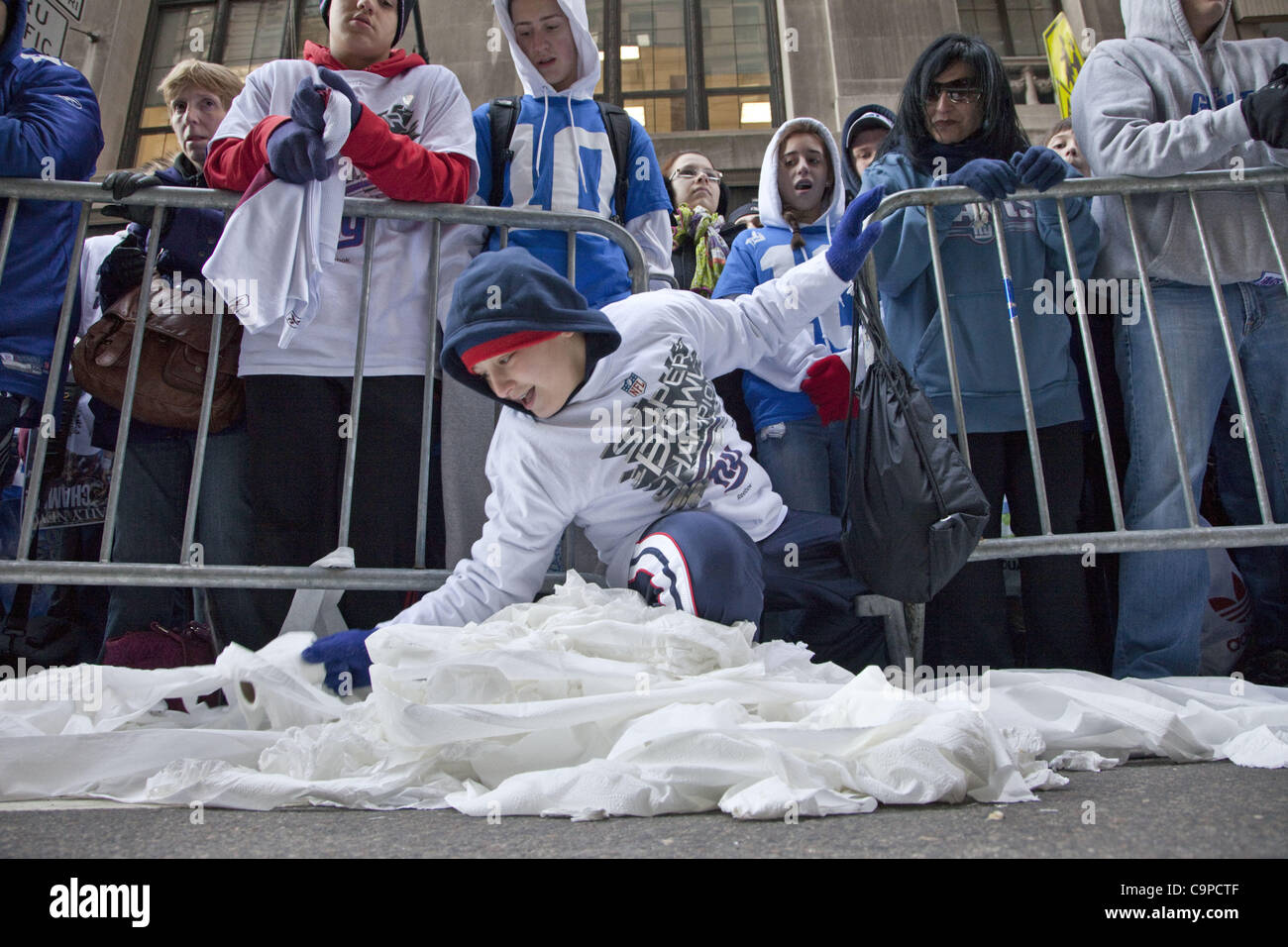 Feb. 7, 2012 - New York, New York, U.S - During the Superbowl Champion Parade a fan collects paper to use in cheering his winning team the New York Giants in Lower Manhattan. (Credit Image: © Gary Dwight Miller/ZUMAPRESS.com) Stock Photo