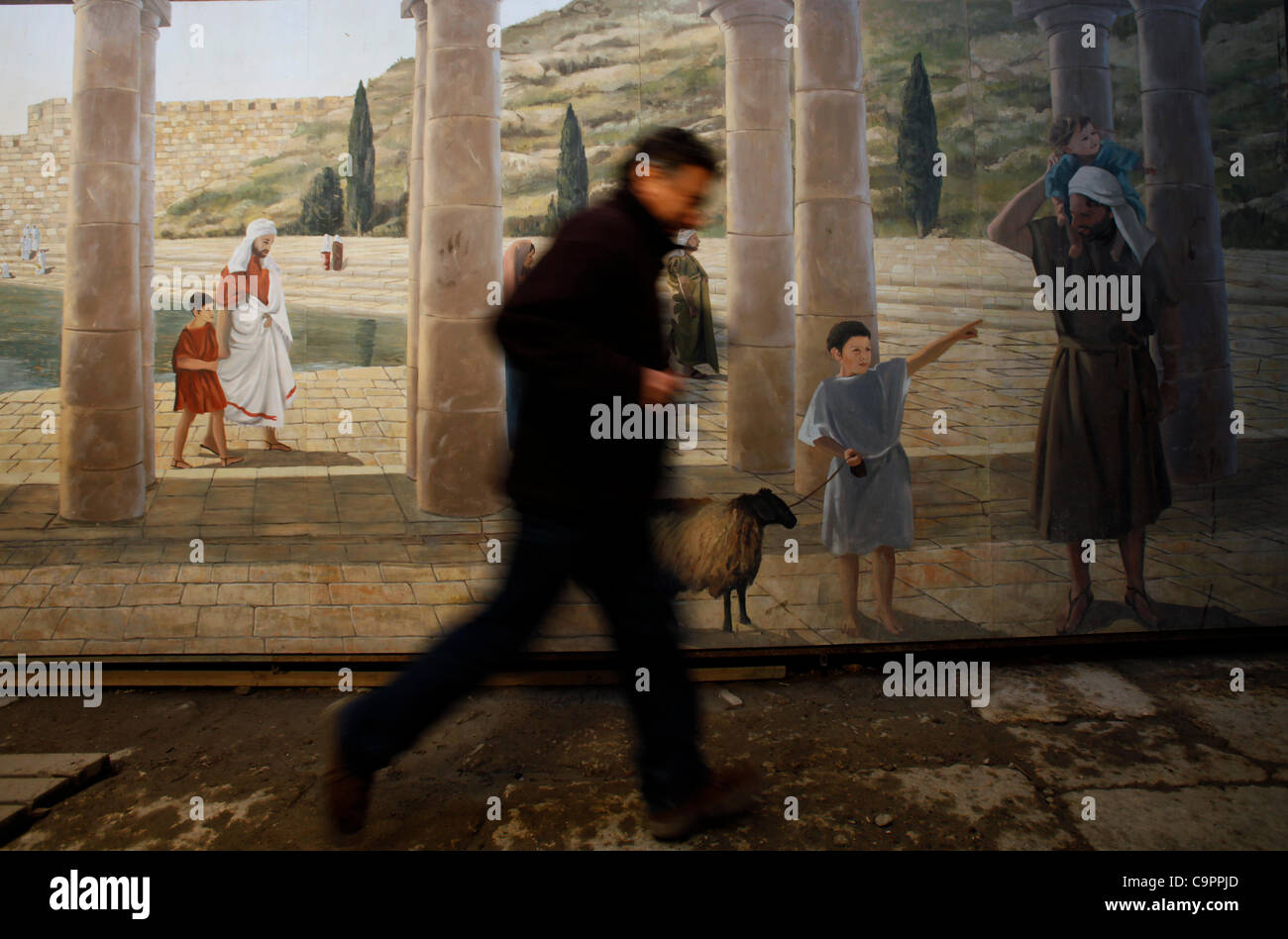 A visitor pass painted wall depicting life in biblical times in the ancient underground Hezekiah's Tunnel East Jerusalem Israel Stock Photo
