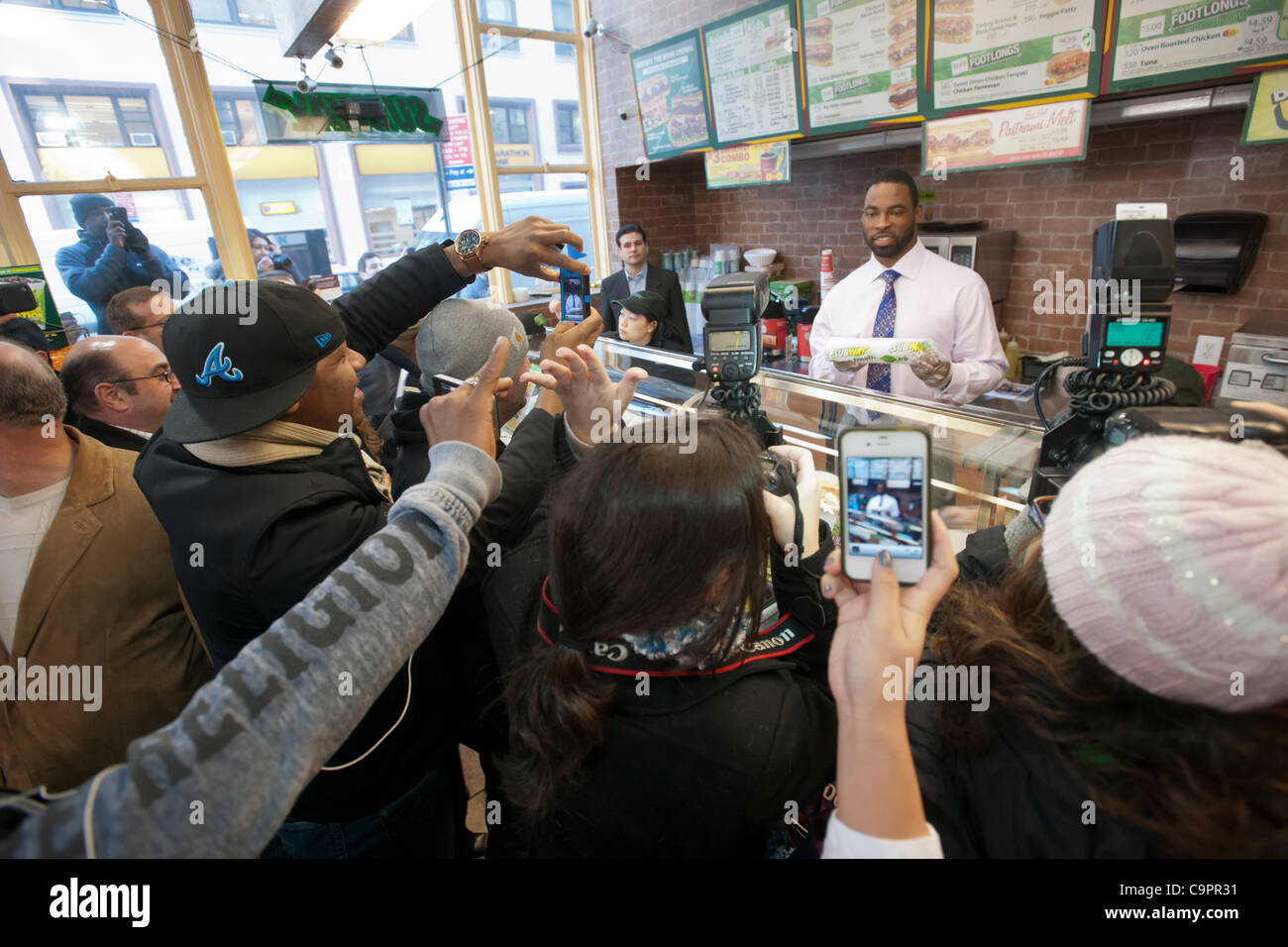 New York Giants defensive end Justin Tuck, fresh off of the Giants' Superbowl win, visits a Subway sandwich restaurant in New York on Thursday, February 9, 2012. The footballer surprised fans by preparing sandwiches and greeting them during the Subway FebruANY Footlong promotion. ( © Richard B. Levi Stock Photo