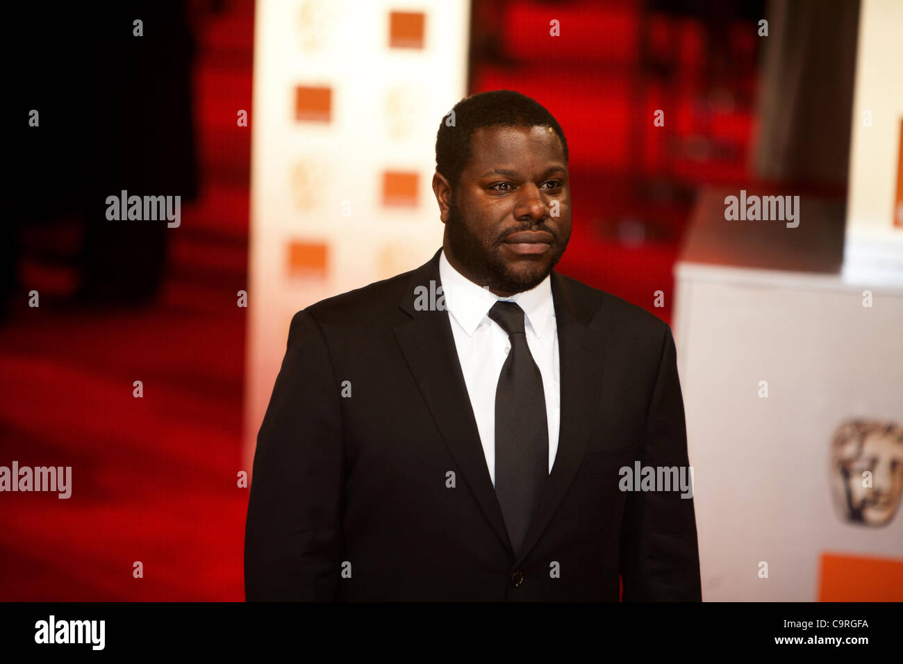London, UK, 12/02/2012. Artist and film director,  Steve McQueen, on the red carpet, arriving to attend the 2012 BAFTAs Stock Photo