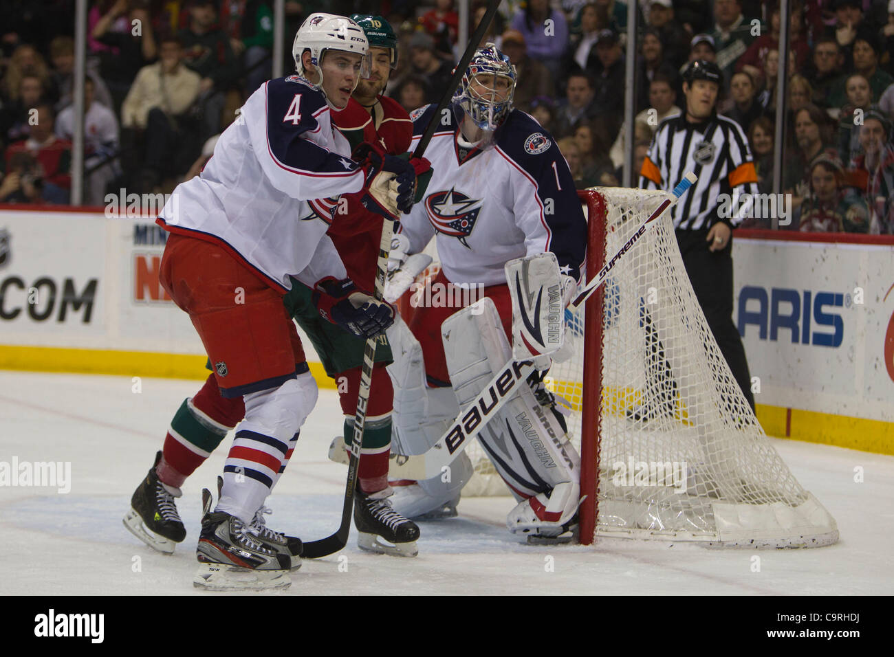 Feb. 11, 2012 - St. Paul, Minnesota, U.S - Columbus Blue Jackets defenseman John Moore (4) and Minnesota Wild right wing Devin Setoguchi (10) gather in front of goalie Steve Mason (1) in the second period of a hockey game between the Columbus Blue Jackets at the Minnesota Wild at the Xcel Energy Cen Stock Photo