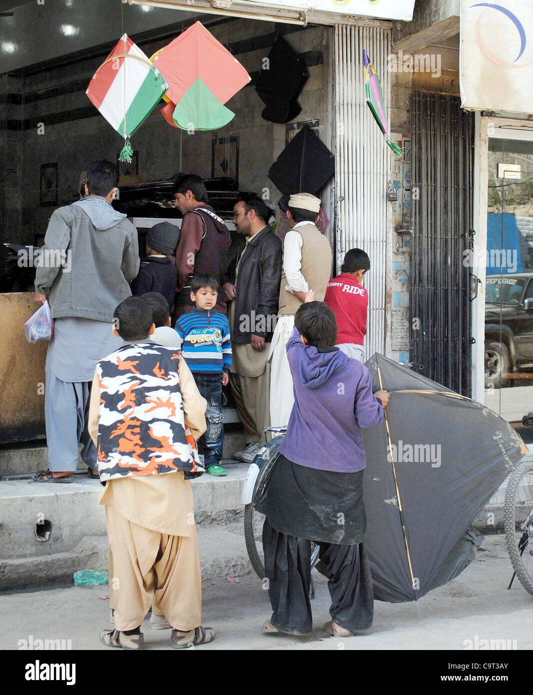 People buy kites and strings at a shop in Quetta on Thursday, February 16, 2012. Stock Photo