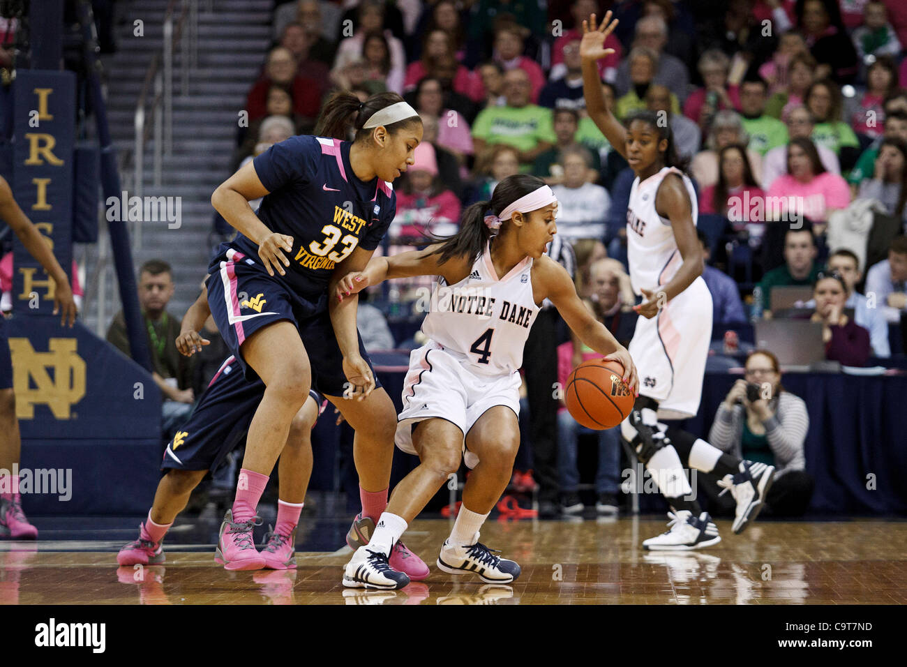 Feb. 12, 2012 - South Bend, Indiana, U.S - Notre Dame guard Skylar Diggins (#4) dribbles the ball as West Virginia center Ayana Dunning (#33) defends in first half action of NCAA Women's basketball game between West Virginia and Notre Dame.  The West Virginia Mountaineers upset the Notre Dame Fighti Stock Photo
