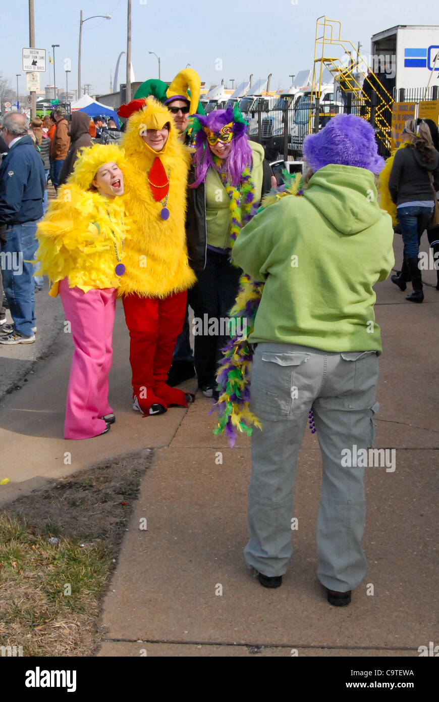 Feb. 18, 2012 - Saint Louis, Missouri, U.S - Two strangers stop to have their picture taken with Ian Starr and Becky Everding in their chicken costumes.  Ian and Becky were big hits with the parade watchers during the 2012 Mardi Gras parade and festival at the Soulard District in St. Louis, MO. (Cre Stock Photo
