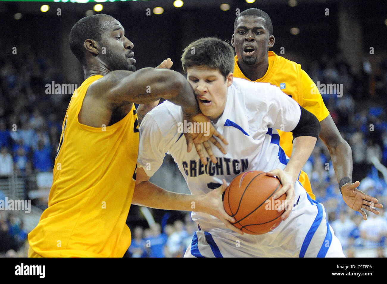 Feb. 18, 2012 - Omaha, Nebraska, U.S - Creighton forward Doug McDermott (3) takes an elbow from Long Beach State forward TJ Robinson (20) as Long Beach State guard Larry Anderson (21)looks on. Creighton defeated Long Beach State 81-79 in a BracketBuster game played at the CenturyLink Center in Omaha Stock Photo