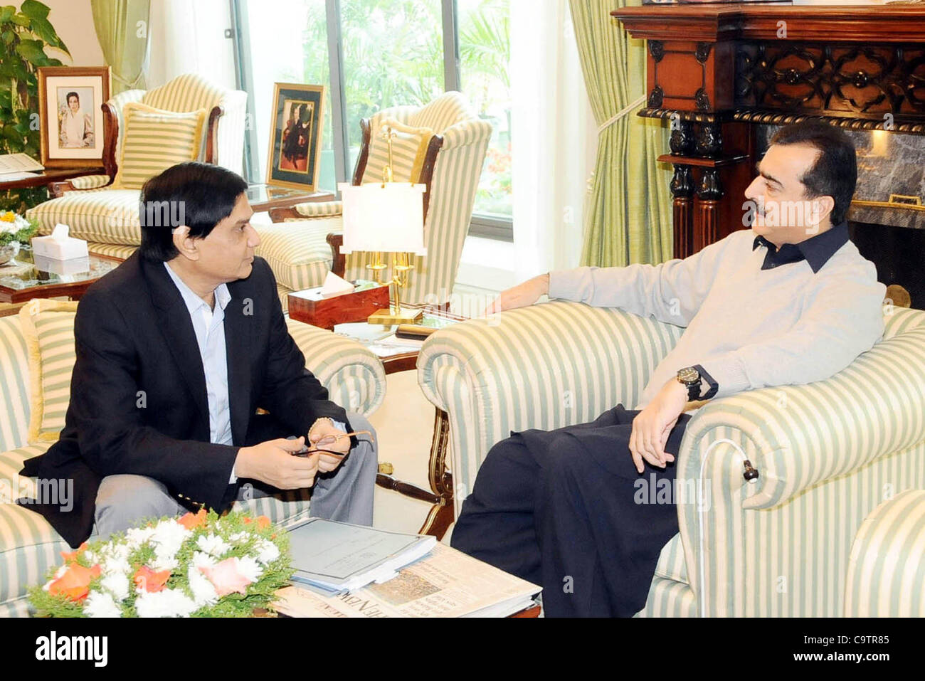 Prime Minister, Syed Yousuf Raza Gilani talks with  Senator Islamuddin Shaikh during meeting at PM House in Islamabad on Monday,  February 20, 2012. Stock Photo