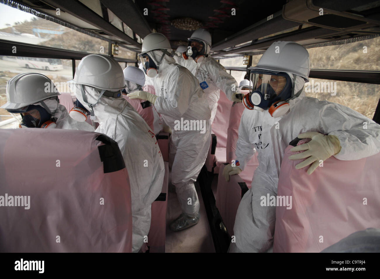 Feb. 20, 2012 - Fukushima, Japan - Tokyo Electric Power Company officials and members of the media look at TEPCO's Fukushima Daiichi nuclear power plant from bus windows. The journalists were let into the plant ahead of the anniversary of the March 11, 2011 tsunami and earthquake for the second time Stock Photo