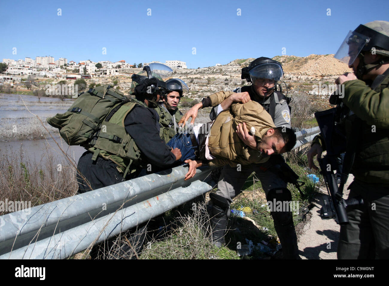 Feb. 21, 2012 - Ramallah, West Bank - Israeli soldiers detain a Palestinian protester at the entrance of Ofer Prison near Ramallah in the occupied West Bank during a demonstration in support of a fellow prisoner. Khader Adnan, 33, was arrested on Dec. 17 and began refusing food a day later to protes Stock Photo