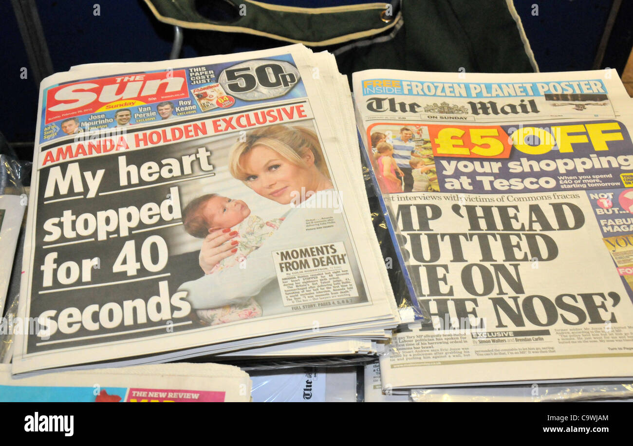 London 26/2/12. Sun on Sunday is put on sale in central London. Newspapers on sale outside Leicester Square Underground station. Stock Photo