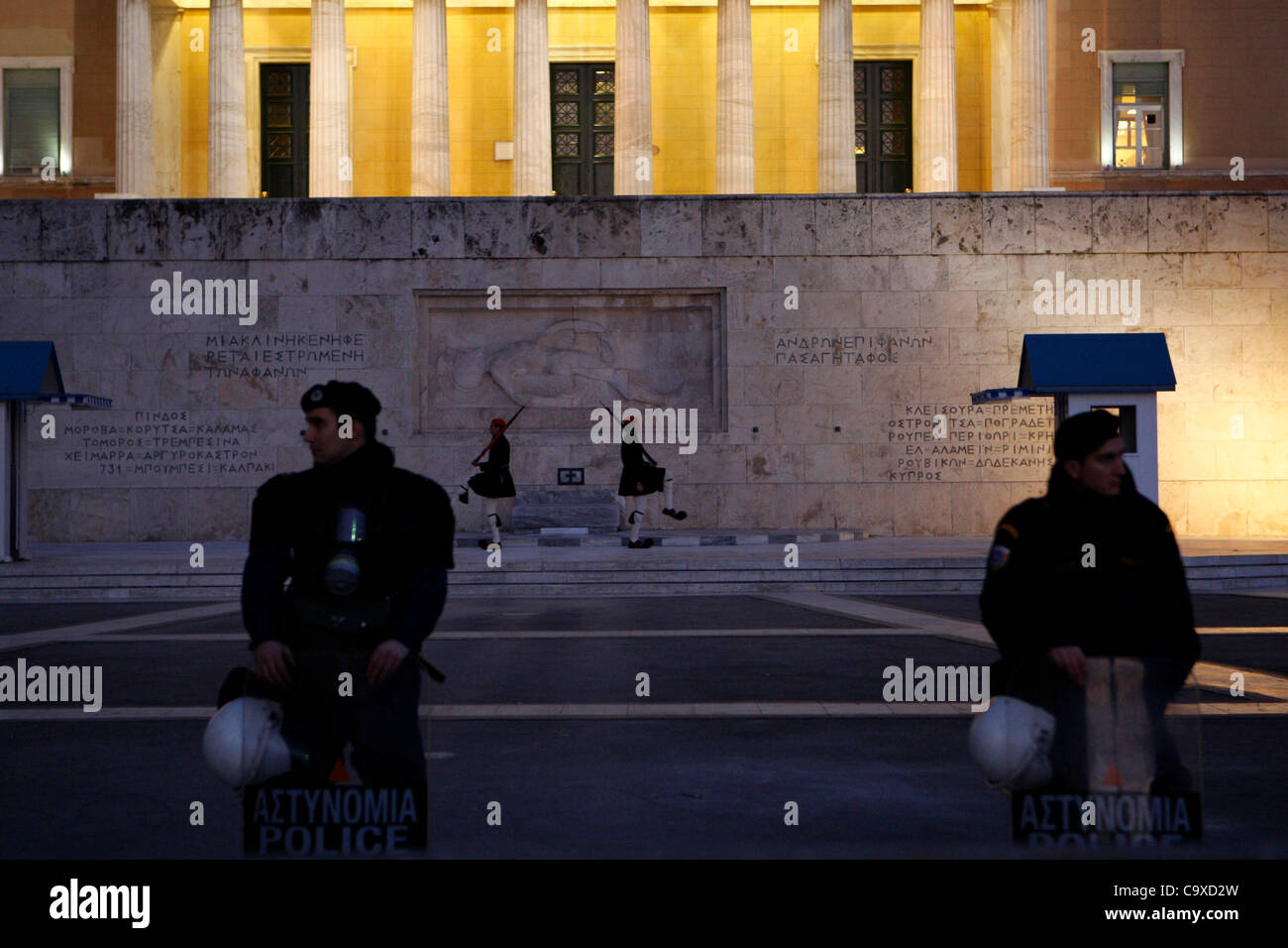 Feb. 29, 2012 - Athens, Greece - Riot policemen and in the background the presidential guard outside the Greek parliament. Trade Union Confederation has called on allits members in 36 European states to take part in this day against austerity measures. (Credit Image: © Aristidis Vafeiadakis/ZUMAPRES Stock Photo