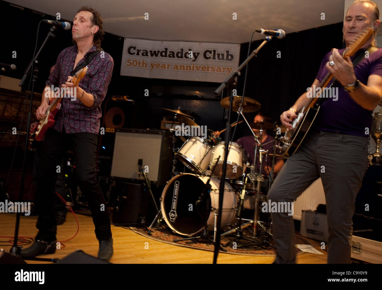 The iconic Crawdaddy Club is being revived on its 50th anniversary year at The Richmond Athletic Ground, where gigs were held in the 60's. The Blue Bishops perform, from left to right: Geoff Grange, Justin Hildreth and Simon Burrett. Stock Photo