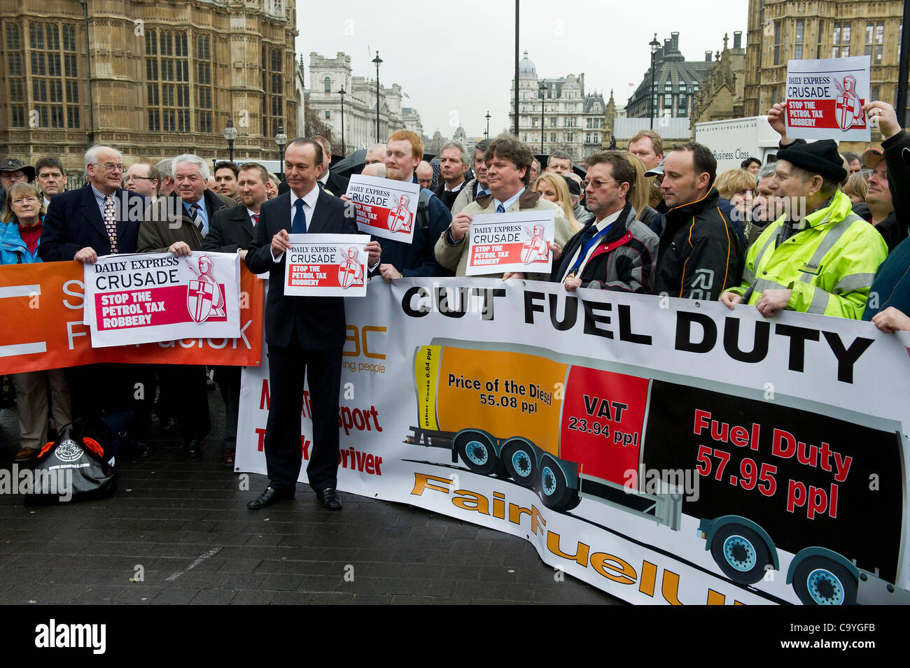 Quentin Willson, ex Top Gear, leads the protest (in front of banner). The campaign for fair fuel prices, supported by the RAC, arranges a mass lobby of their MP's over the cost of fuel duty and its impact on motorists. Westminster, London, UK, 7 March 2012. Stock Photo