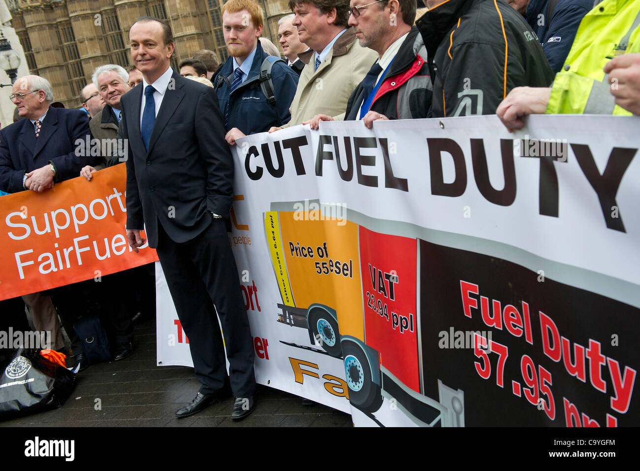 Quentin Willson, ex Top Gear, leads the protest (in front of banner). The campaign for fair fuel prices, supported by the RAC, arranges a mass lobby of their MP's over the cost of fuel duty and its impact on motorists. Westminster, London, UK, 7 March 2012. Stock Photo