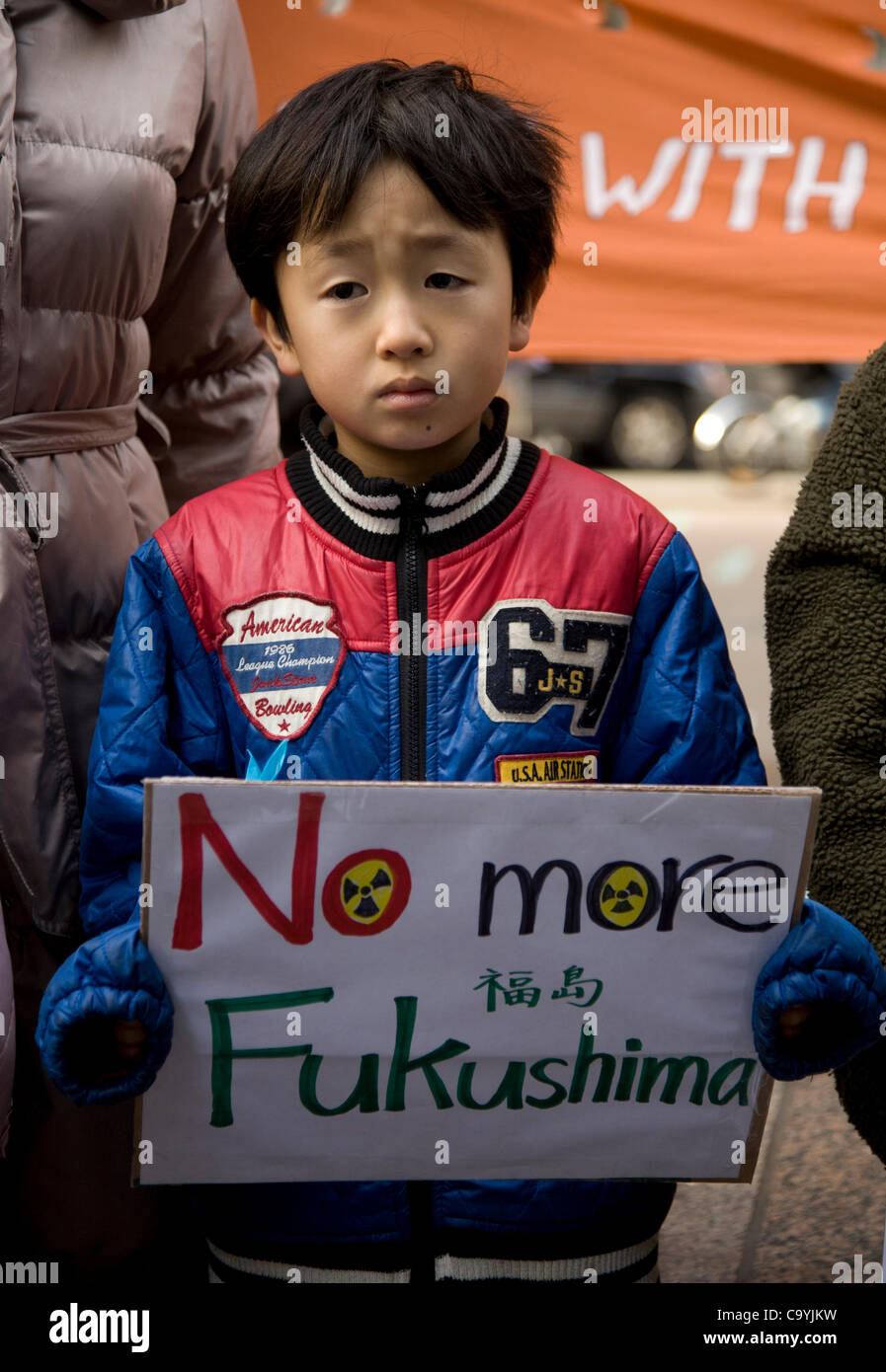 Young boy with family from Fukushima area of Japan in NYC to urge Americans to turn away from nuclear power and shut down the Indian Point plant. March 8, 2012. Buddhist Peace Walk at 1 year anniv. of the Fukushima Nuclear Disaster that is still going on. Stock Photo