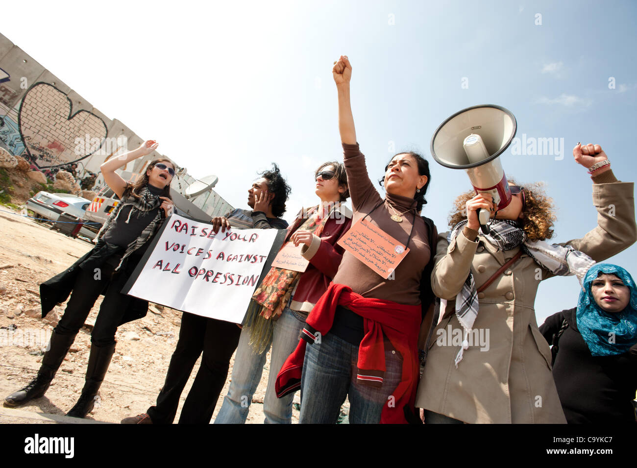 KALANDIA, OCCUPIED PALESTINIAN TERRITORIES - MARCH 8: Palestinian women, joined by Israeli and international solidarity activsits march to the Kalandia checkpoint to protest the Israeli occupation of Palestine on International Women's Day 2012. Stock Photo