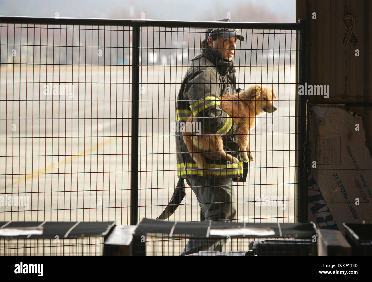 March 9, 2012 - London, Kentucky, USA - Brandon Zacharias, a member of the East Bernstadt Fire Department, brings into The Humane Society of the United States emergency animal shelter a dog he found in the aftermath of tornados that tore through East Bernstadt and areas around London, Ky. The emerge Stock Photo