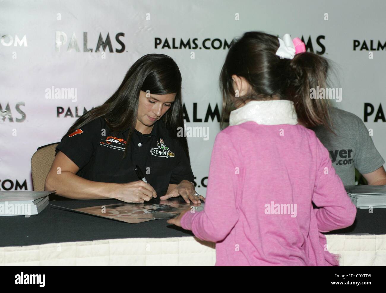 Danica Patrick, young fan in attendance for JR Motorsports Presents NASCAR Autograph Signing, Palms Casino Resort Hotel, Las Vegas, NV March 9, 2012. Photo By: James Atoa/Everett Collection Stock Photo