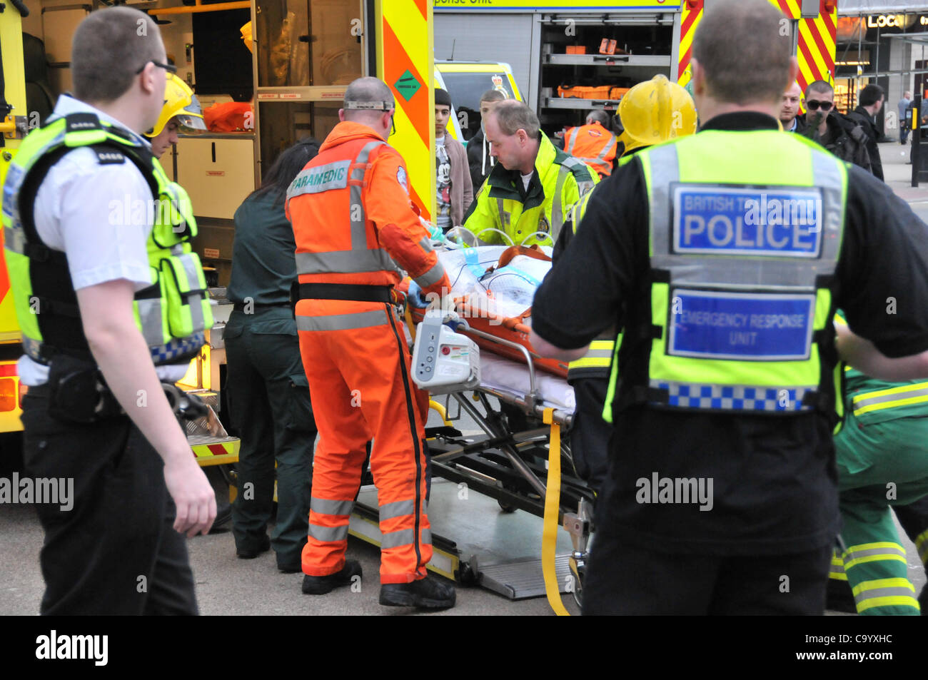 Wood Green London 10/3/12 Person under a train at Wood Green Underground station, paramedics, ambulance staff and police attend the scene as the station is closed to recover the person alive. The injured person is put into the ambulance just after leaving the station. Stock Photo