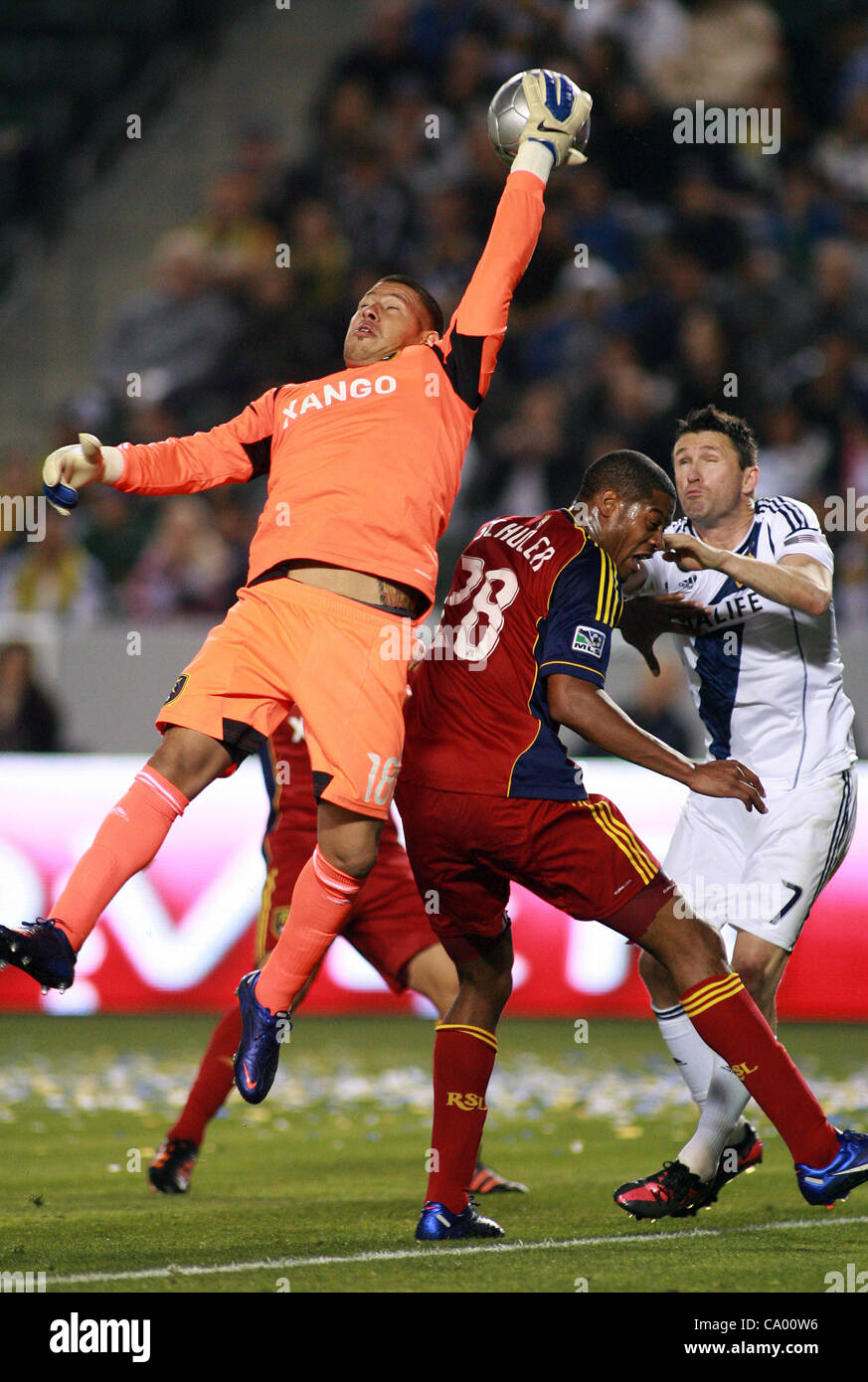 March 10, 2012 - Los Angeles, California, U.S. - Goalkeeper Nick Rimando #18 of Real Salt Lake punches the ball away for a save from Chris Schuler #28 of the Los Angeles Galaxy during the MLS match at The Home Depot Center on March 10, 2012 in Carson, California. Real Salt Lake defeated the Galaxy 3 Stock Photo