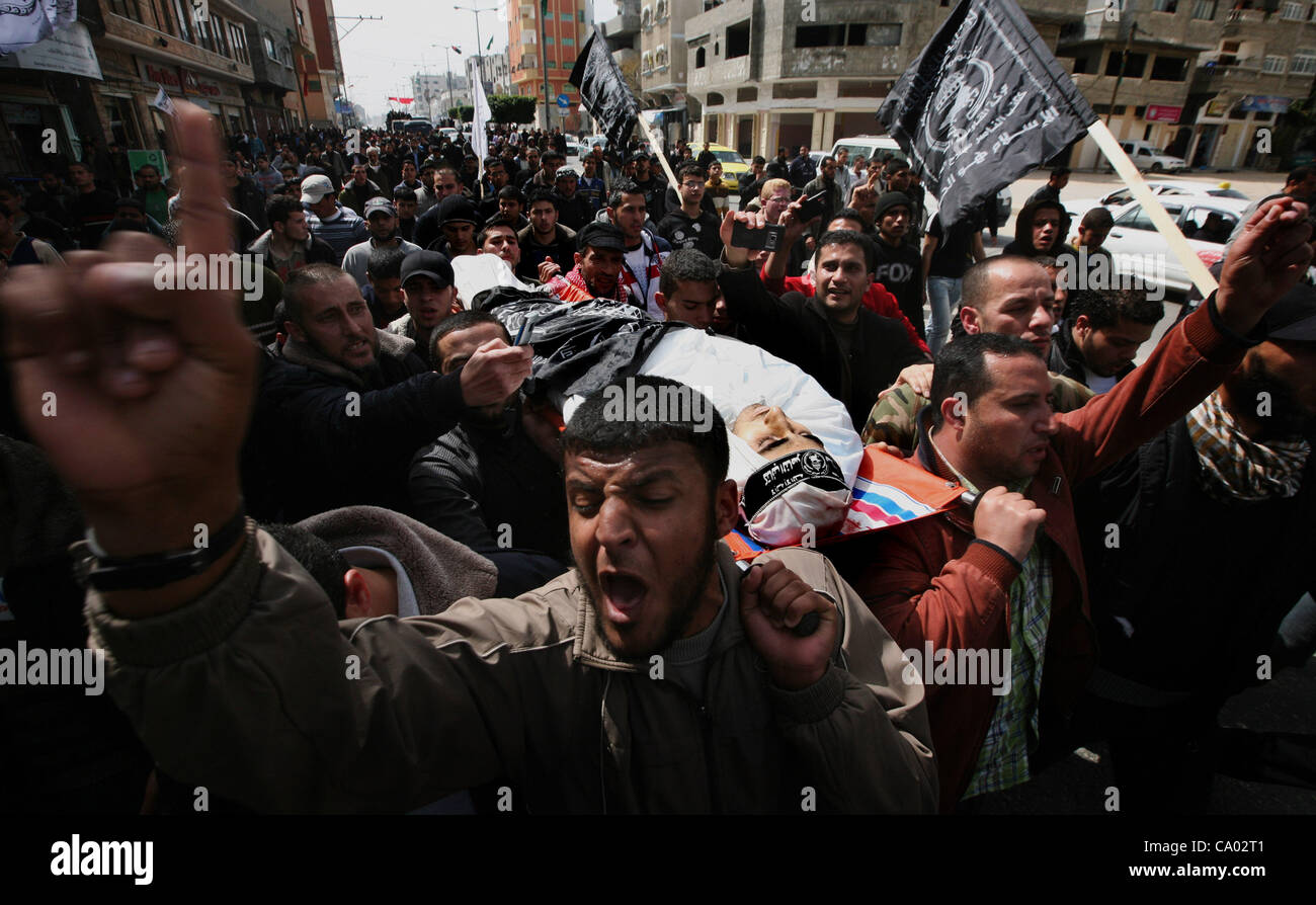 March 11, 2012 - Gaza City, Gaza Strip - Palestinians carry the body of Ahmed Salim during his funeral in Gaza City on Sunday. The worst round of violence in more than a year between Israel and Gaza Strip Palestinians deepened Sunday with deadly Israeli airstrikes and a barrage of rockets fired into Stock Photo