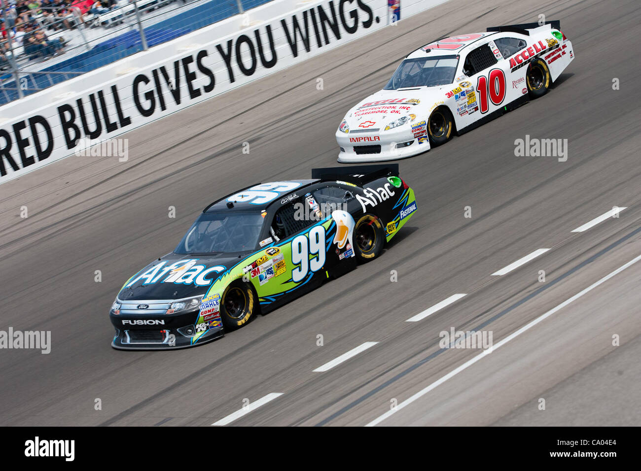 March 11, 2012 - Las Vegas, Nevada, U.S - Carl Edwards, driver of the #99 Aflac Ford Fusion, passes the lap car of David Reutimann, driver of the #10 Accell Construction Chevrolet Impala, during the exciting racing action at the NASCAR Sprint Cup Series Kobalt Tools 400 at Las Vegas Motor Speedway i Stock Photo
