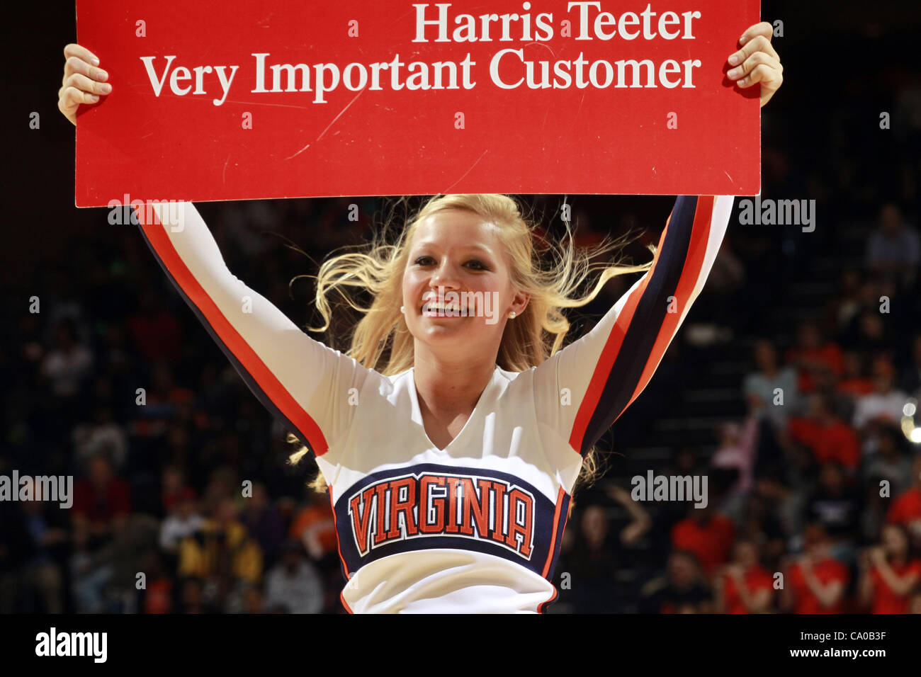 Nov. 20, 2011 - Charlottesville, Virginia, United States - Virginia Cavaliers cheerleaders hold up a Harris Teeter Vic card sign during the game on November 20, 2011 against the Tennessee Lady Volunteers at the John Paul Jones Arena in Charlottesville, Virginia. Virginia defeated Tennessee in overti Stock Photo