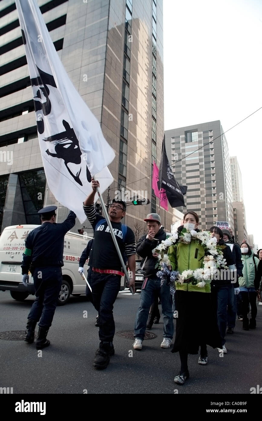 March 11, 2012, Tokyo, Japan - At the front of the rally a white flag and a funeral wreath against nuclear energy and also to commemorate the first anniversary of the Great East Japan Earthquake. Many protesters carrying banners took to the streets of Tokyo to demonstrate against nuclear power on th Stock Photo