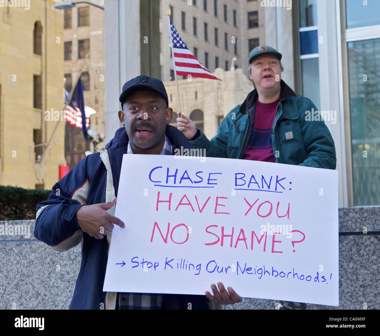 Detroit, USA. 13 Mar, 2012. A protester holds a sign at a rally against the foreclosure polices of Chase Bank in Detroit, Michigan. About 200 people marched from the statue of the Spirit of Detroit to the bank. Stock Photo