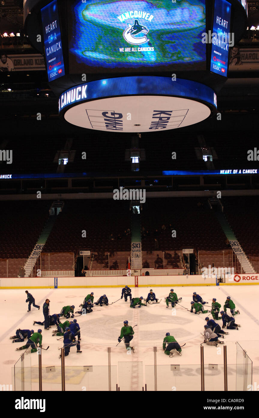 210406) -- VANCOUVER, Aprilil 6, 2021 (Xinhua) -- A resident walks past a  poster with an image of a Canucks player outside Rogers Arena in Vancouver,  British Columbia, Canada, April 5, 2021.