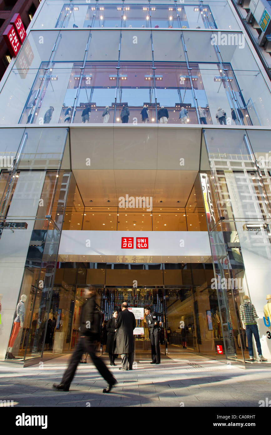 March 15, 2012, Tokyo, Japan - Pedestrians walk past the new Uniqlo store in downtown Tokyo. Fast Retailing's Uniqlo brand will open its world's largest flagship store to date on March 16 in the Ginza shopping district of Tokyo. This new megastore will consist of 12 floors offering various types of  Stock Photo