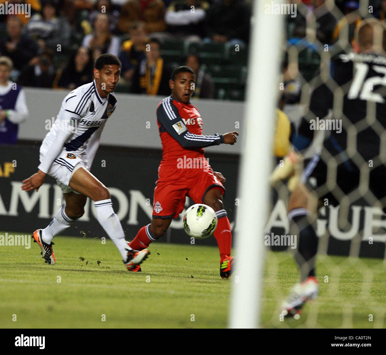 March 14, 2012 - Los Angeles, California, U.S. - JOU PLATA #7 of Toronto FC shoots the ball against SEAN FRANKLIN #5 of the Los Angeles Galaxy during a Confederation of North, Central American and Caribbean Association Football (CONCACAF) Champions League game at The Home Depot Center in Carson. Tor Stock Photo