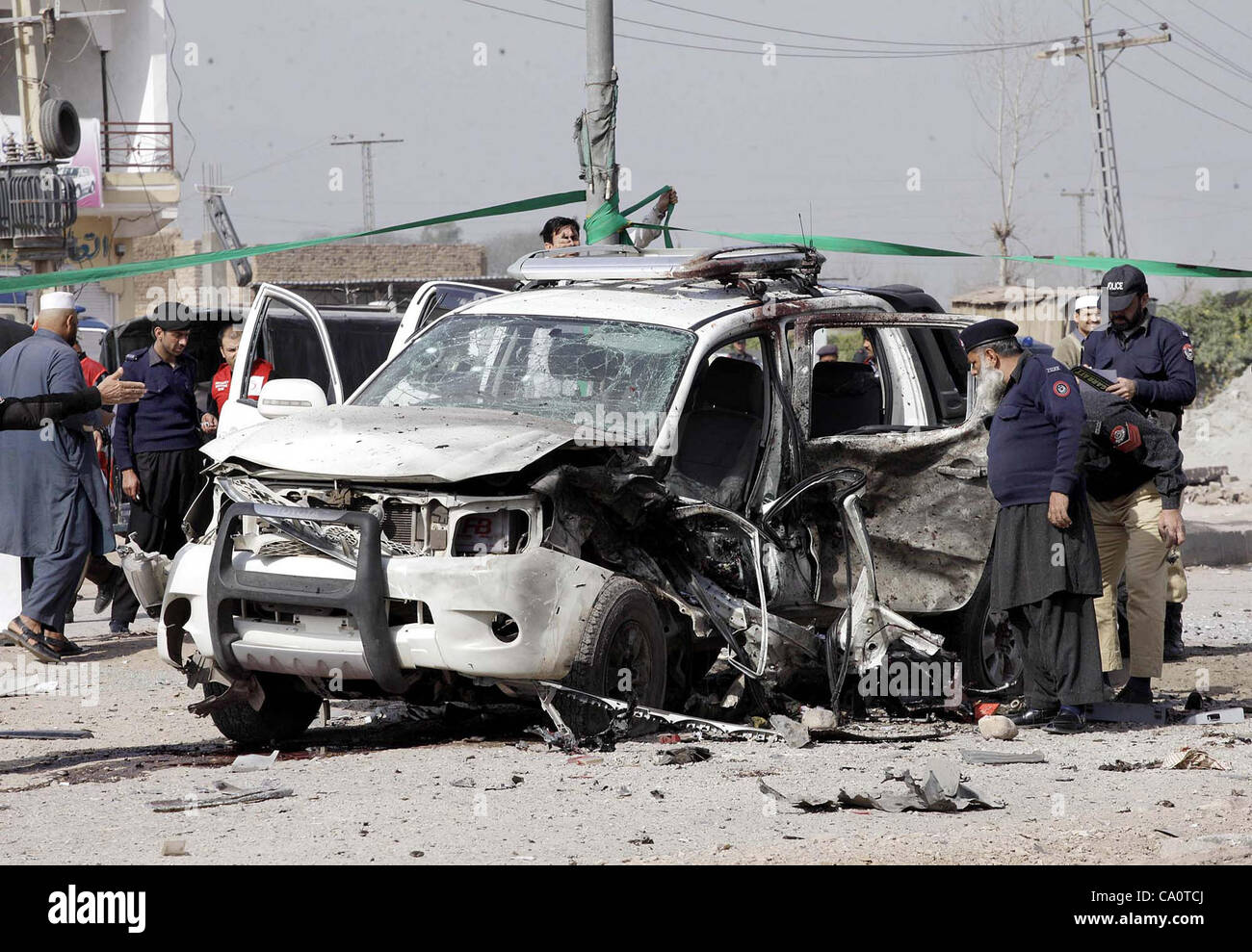 Police Officers Inspect Wreckage Of Vehicle, Which Was Destroyed In ...