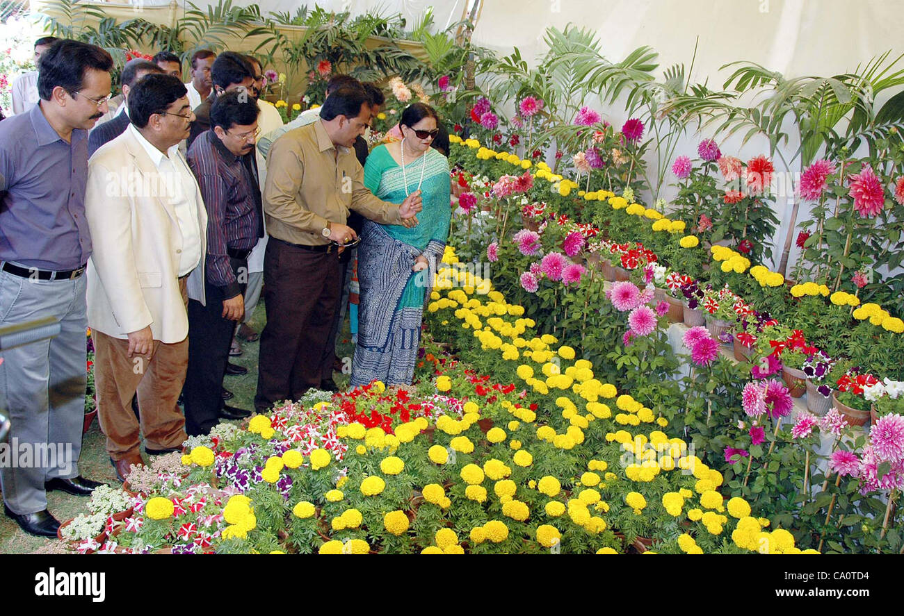 Senator Nasreen Jalil looks flowers during inauguration ceremony of flowers show in connection