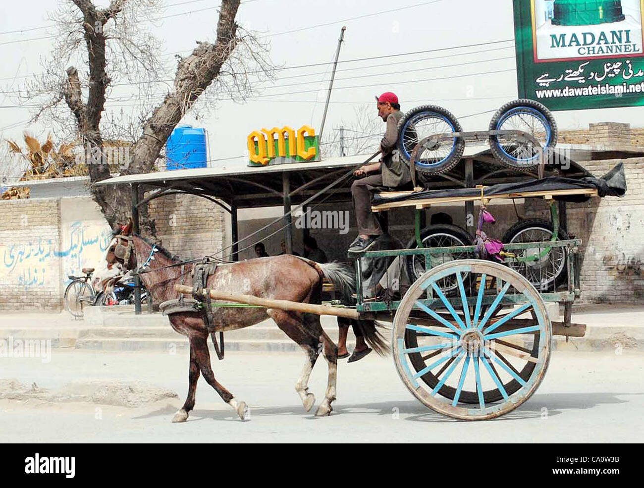 A horsecart rider carries pushcarts to earn his livelihood for