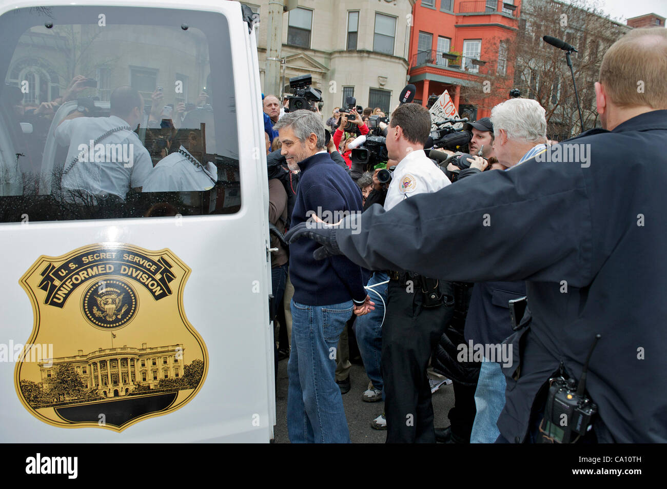 March 16, 2012 - Washington, District of Columbia, U.S. - Actor GEORGE CLOONEY is taken to a prisoner transport vehicle after he, his father Nick Clooney, members of Congress, human rights and faith leaders were arrested for protesting at the Embassy of Sudan. (Credit Image: © Mary F. Calvert/ZUMAPR Stock Photo