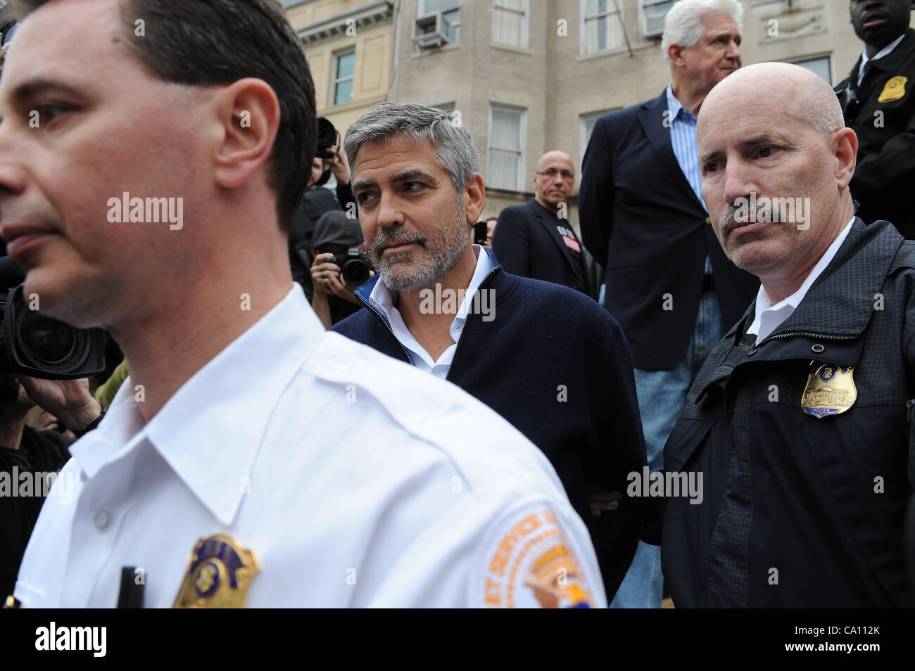 March 16, 2012 - Washington, District of Columbia, U.S. - .Actor George Clooney joins protesters in front of the Embassy of Sudan as he speaks out to end the  violence and killing of the people in the country of Sudan. George Clooney is arrested. Stock Photo