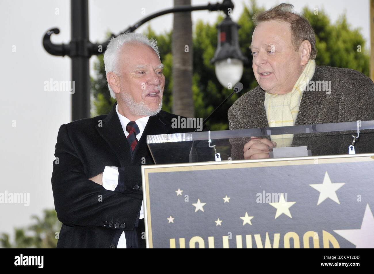 Malcolm McDowell, Mike Kaplan at the induction ceremony for Star on the Hollywood Walk of Fame for Malcolm McDowell, Hollywood Boulevard, Los Angeles, CA March 16, 2012. Photo By: Michael Germana/Everett Collection Stock Photo