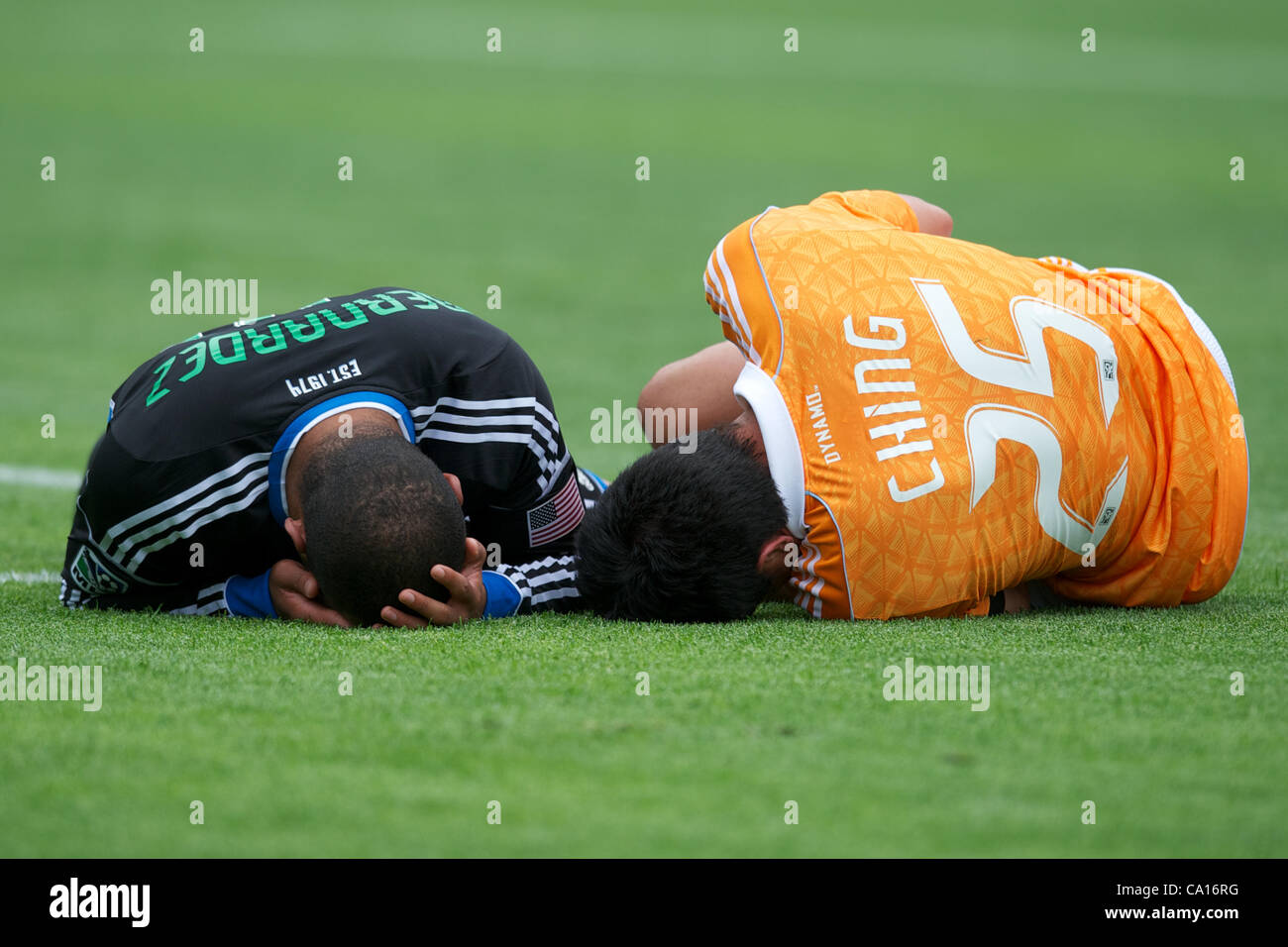 March 17, 2012 - San Francisco, California, U.S - Earthquakes defender Victor Bernardez (26) and Dynamo forward Brian Ching (25) hold their heads after colliding in the box during the MLS match between the San Jose Earthquakes and Houston Dynamo at AT&T Park in San Francisco, CA.  The Dynamo lead 1- Stock Photo