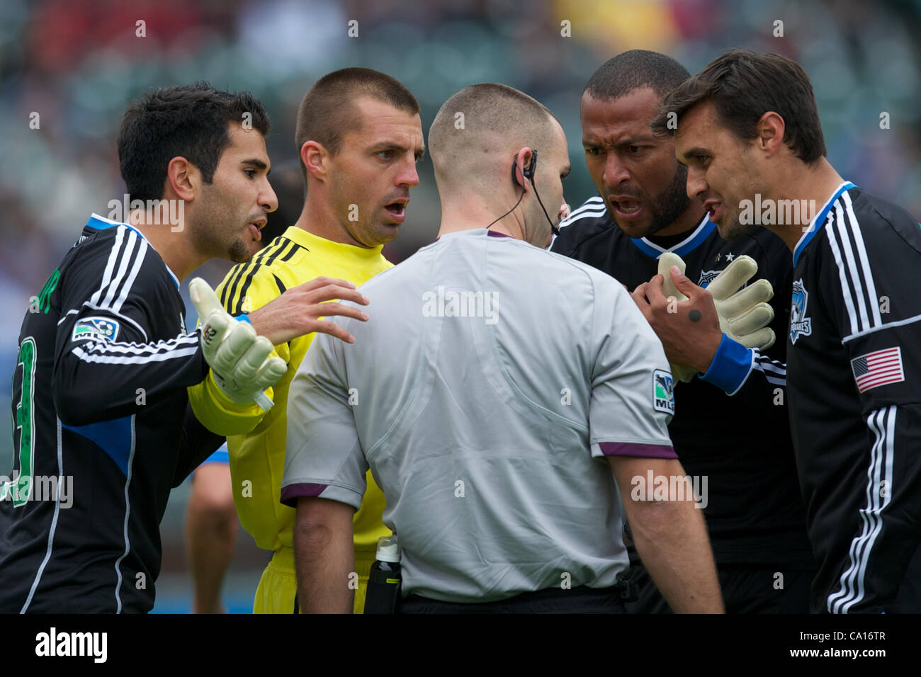 March 17, 2012 - San Francisco, California, U.S - Earthquakes defender Steven Beitashour (33), goalkeeper Jon Busch (18), defender Victor Bernardez (26), and forward Chris Wondolowski (8)  argue with referee Chris Penso after Penso awarded Houston a penalty kick during the MLS match between the San  Stock Photo