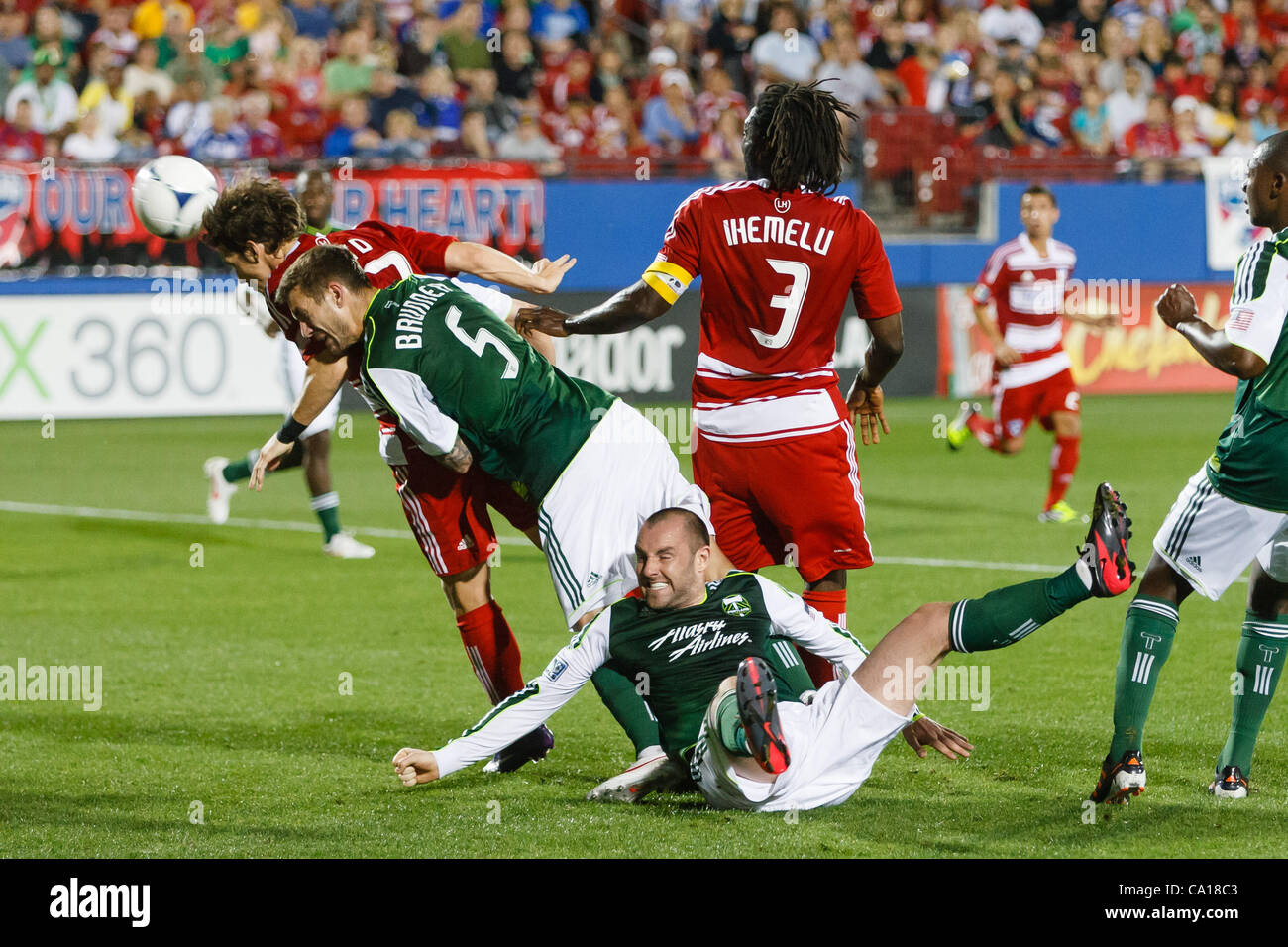 March 17, 2012 - Frisco, Texas, US - A scramble for a header by FC Dallas defenders Zach Loyd (17), Ugo Ihemelu (3) and Portland Timbers defender Eric Brunner (5) and forward Kris Boyd (9) of Scotland during action between FC Dallas and Portland Timbers.  FC Dallas and Portland draw their match 1-1  Stock Photo