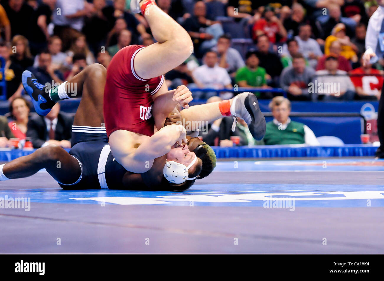March 17, 2012 - St. Louis, Missouri, United States of America - Edward Ruth (blue) of Penn State attempts to roll Nick Amuchastegui (red) of Stanford into a pin during a championship match of the NCAA Division 1 Wrestling Championships in St. Louis, MO.  Edward Ruth won to become the NCAA Division  Stock Photo
