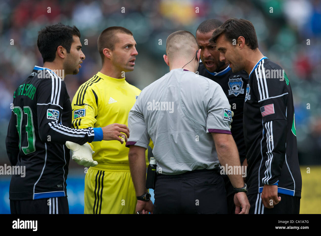 March 17, 2012 - San Francisco, California, U.S - Earthquakes defender Steven Beitashour (33), goalkeeper Jon Busch (18), defender Victor Bernardez (26), and forward Chris Wondolowski (8)  argue with referee Chris Penso after Penso awarded Houston a penalty kick during the MLS match between the San  Stock Photo