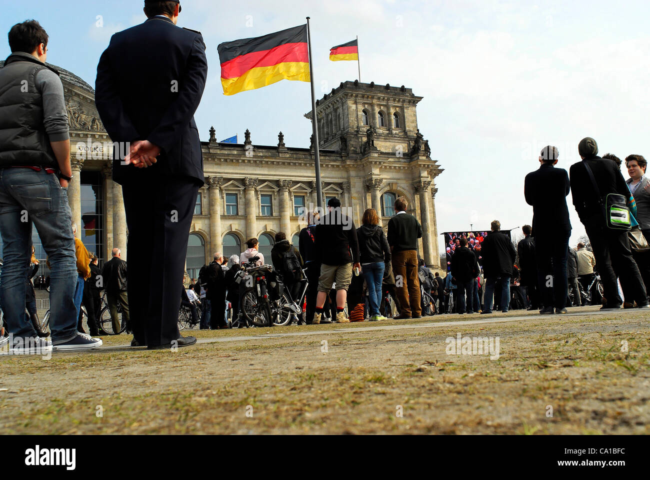 Scenery of a public viewing at the German Reichstag in Berlin, during the election to the new Federal President. It was a sunny Sunday and about 500 People were watching the broadcasting transmission of the election on the field in front of the German Reichstag. Berlin 18th March, 2012. Stock Photo