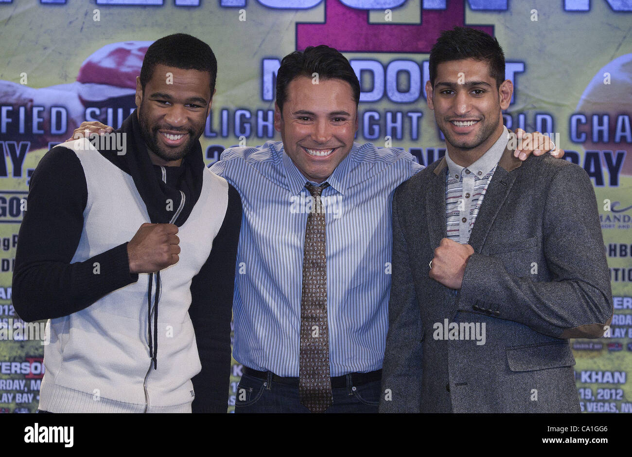 March 19, 2012 - Los Angeles, California, UNITED STATE OF AMERICA - British boxer Amir Khan, left, promoter Oscar de la Hoya, center,  and US boxer Lamont Peterson, right, pose during a press conference at the Grammy Museum in Los Angeles, California on Monday, 19 March 2012.  to promote their upcom Stock Photo
