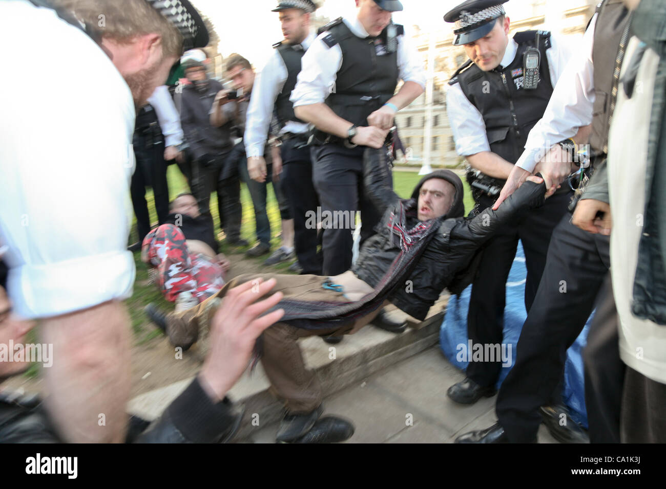 LONDON, UK, 20th Mar, 2012. One of the activists is arrested by police. Activists had gathered in Parliament Square to protest against the proposed anti squatting law being voted on in the house of lords. Stock Photo