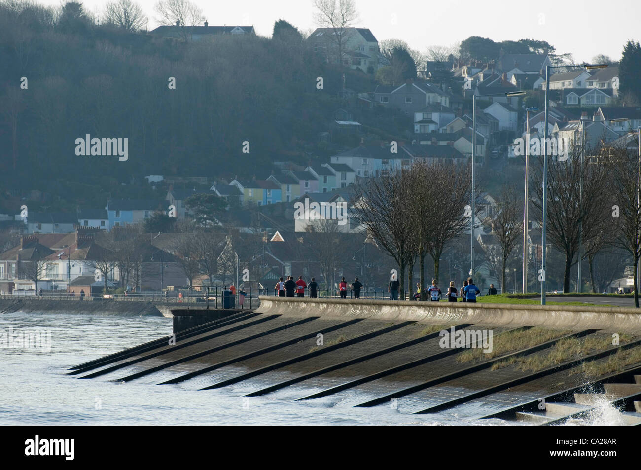 Swansea, Wales, UK, 24/03/2012 Competitors running along the promenade in the sunshine during the Mumbles Duathlon event in Swansea early this morning. The long course is a tough 5k run, 32k bike and finally a 5k run. Stock Photo