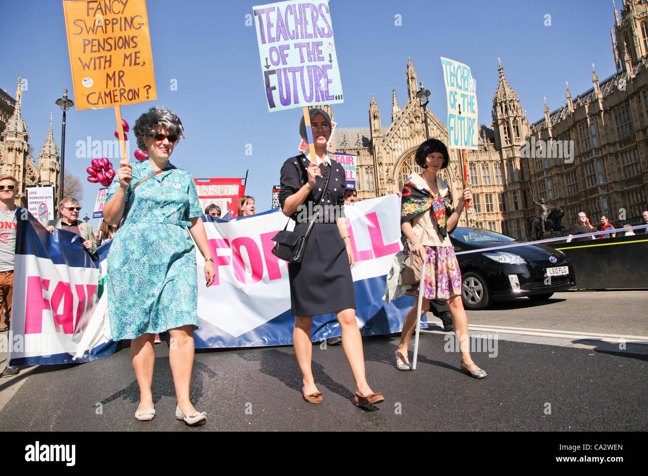 LONDON, UK, 28th Mar, 2012. Protesters dressed as elderly ladies hold placards saying 'teachers of the future' as the march passes Parliament. Thousand of teachers and lecturers gathered in Malet Street before marching to Westminster to protest against the government’s plans for public sector pensio Stock Photo