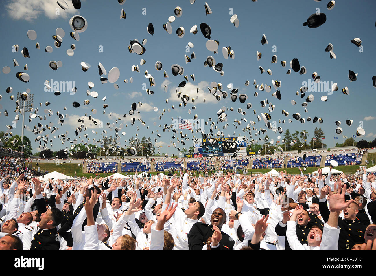 Sailors toss their hats in the air to mark the official closing of the 2012 US Naval Academy graduation and commissioning ceremony May 29, 2012 in Annapolis, MD. Stock Photo