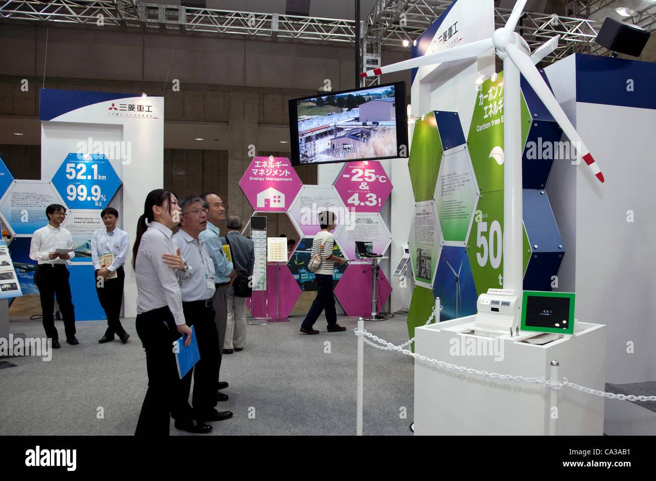 May 131, 2012, Tokyo, Japan - Visitors come to the Smart Grid Exhibition and Automotive Next Industry Fair to watch the new vehicles and manufacturing technologies. The Smart Grid Exhibition and Automotive Next Industry Fair 2012 shows the next generation of vehicles and manufacturing working with e Stock Photo